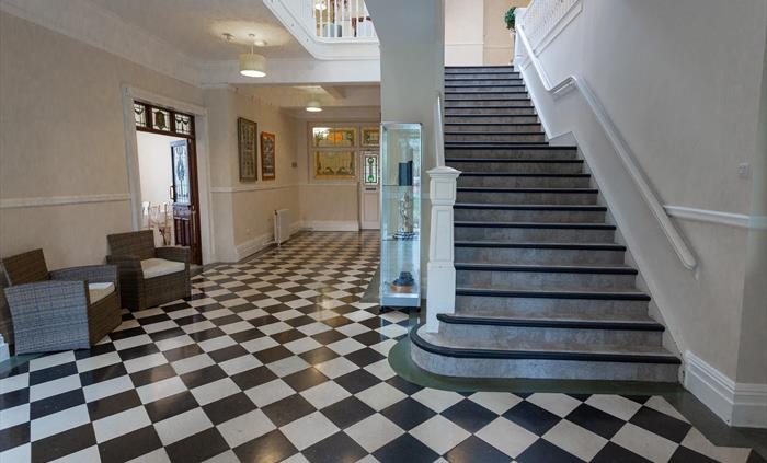 A shot of the hallway and impressive staircase.